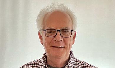 Headshot of Joe Burns in front of a white background.